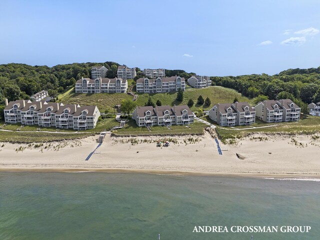 birds eye view of property with a view of the beach and a water view