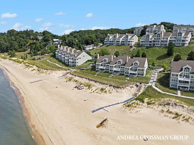 bird's eye view featuring a water view and a view of the beach