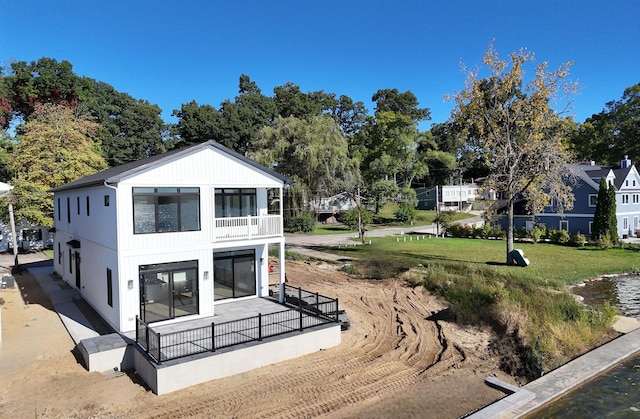 exterior space with a lawn and a balcony