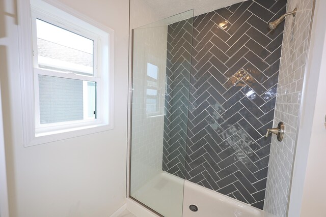 bathroom with a tile shower