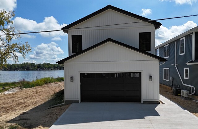 garage with a water view and cooling unit