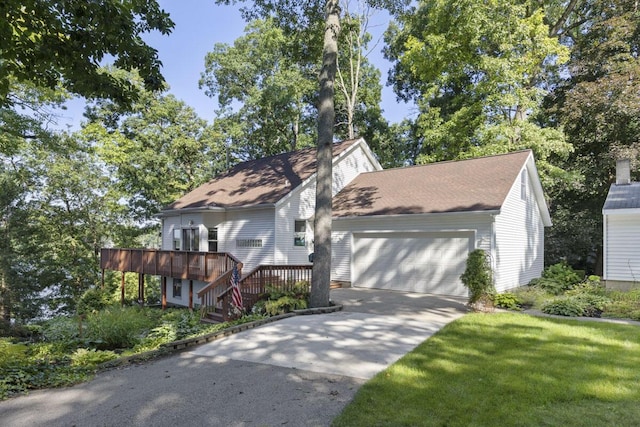 view of front of home featuring a front lawn, a deck, and a garage