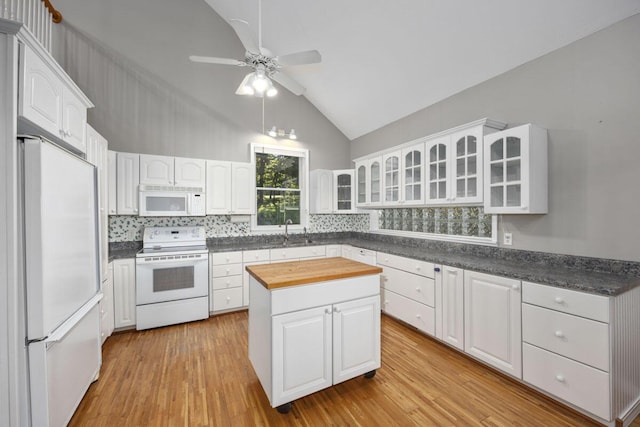 kitchen with a center island, white appliances, white cabinets, and light wood-type flooring