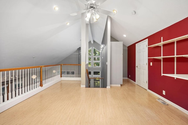 additional living space with ceiling fan, vaulted ceiling, and hardwood / wood-style floors