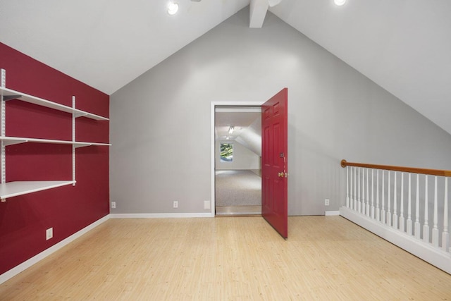 bonus room featuring hardwood / wood-style floors, high vaulted ceiling, and beamed ceiling