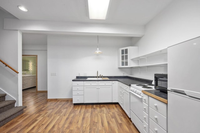 kitchen with white cabinetry, white appliances, sink, and decorative light fixtures