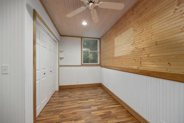 hallway with hardwood / wood-style floors and wood ceiling