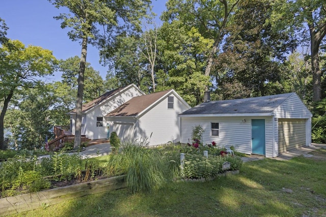 exterior space with a yard, a deck, and an outdoor structure