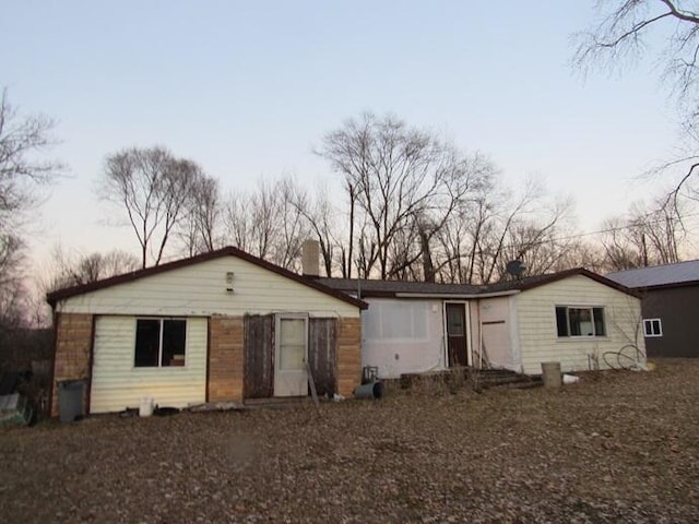 view of back house at dusk