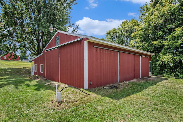 view of outbuilding featuring a lawn