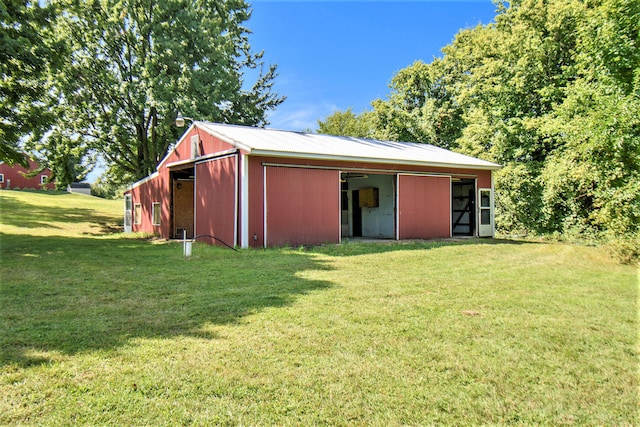 view of outbuilding featuring a lawn