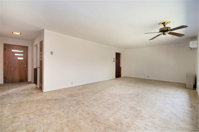 empty room featuring ceiling fan, light carpet, and a wall mounted AC