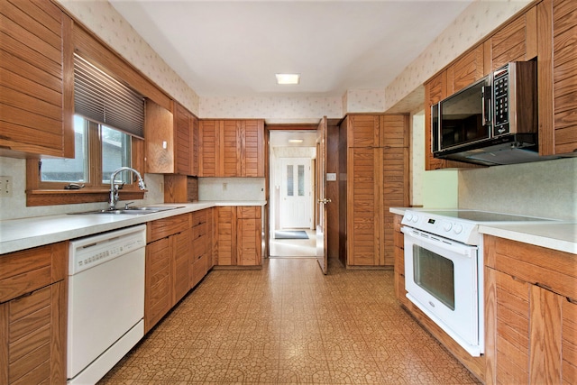 kitchen featuring sink, range, decorative backsplash, dishwasher, and light tile patterned floors