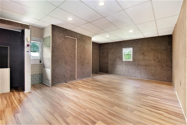 unfurnished room featuring a drop ceiling, recessed lighting, and wood finished floors