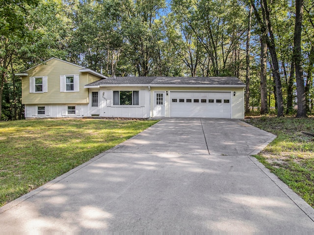 split level home with a front lawn and a garage