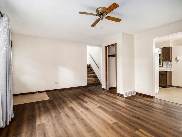 spare room with ceiling fan and wood-type flooring