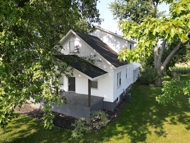 exterior space featuring a lawn and central AC