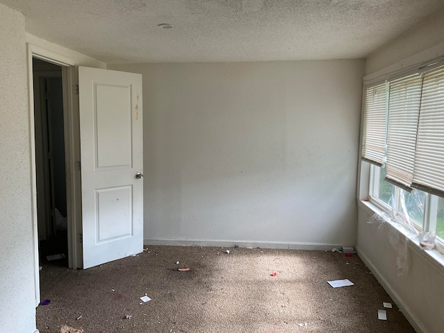 spare room with a textured ceiling