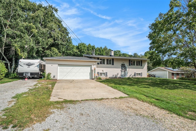 raised ranch featuring a garage and a front lawn