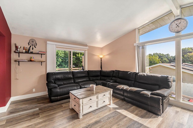 living room with wood-type flooring and lofted ceiling with beams