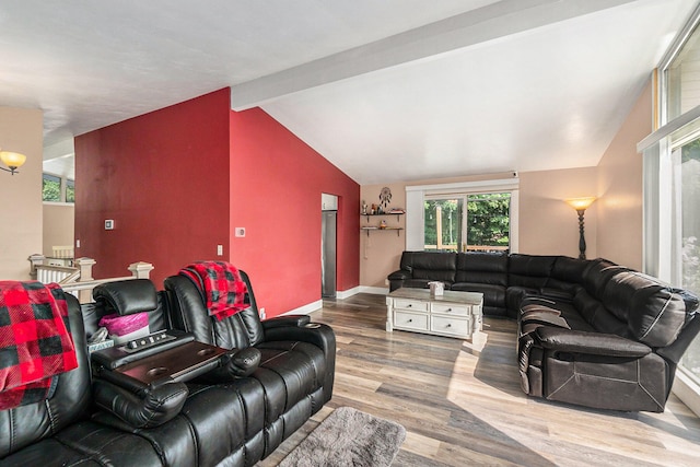 living room with hardwood / wood-style floors and vaulted ceiling with beams