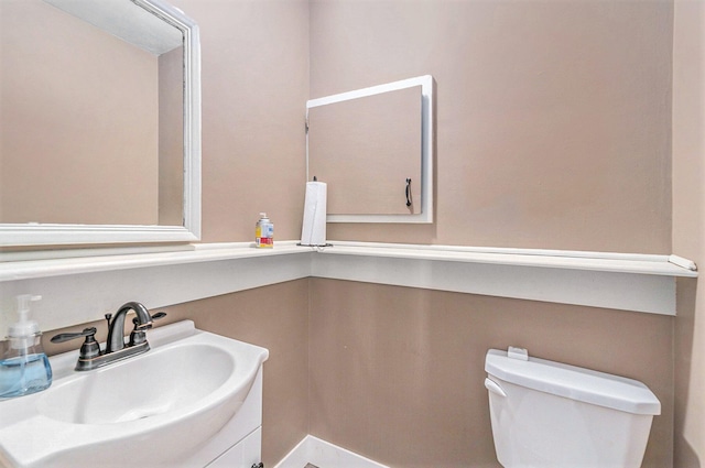 bathroom with toilet and vanity