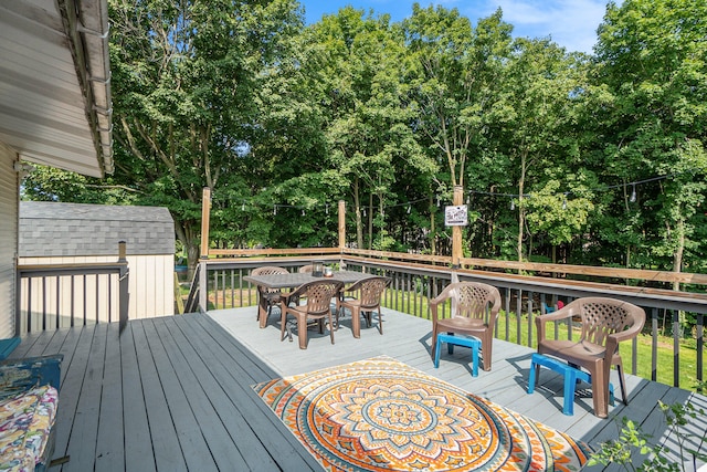 wooden terrace featuring a shed