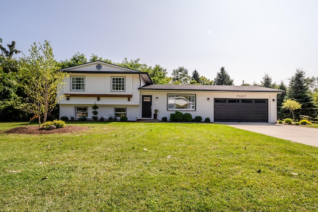 split level home with a garage and a front lawn