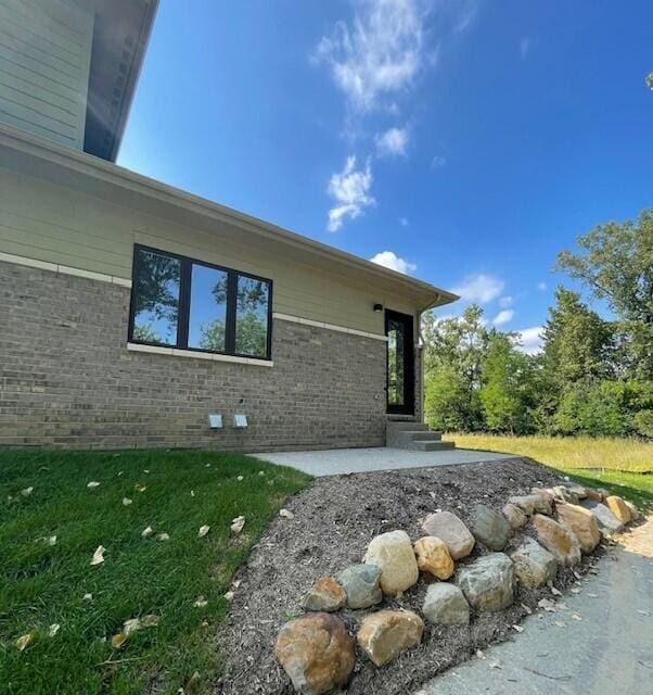 view of property exterior featuring brick siding