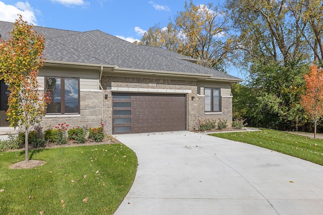 view of front of home with a front yard and a garage