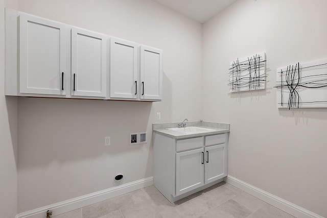 laundry area with a sink, baseboards, cabinet space, and washer hookup