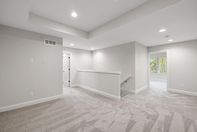 carpeted spare room featuring recessed lighting, visible vents, and baseboards