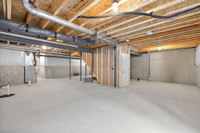 unfinished basement featuring heating unit