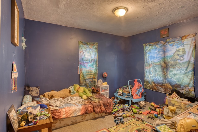 carpeted bedroom featuring a textured ceiling