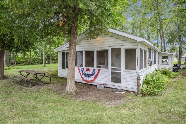 view of outbuilding with a lawn