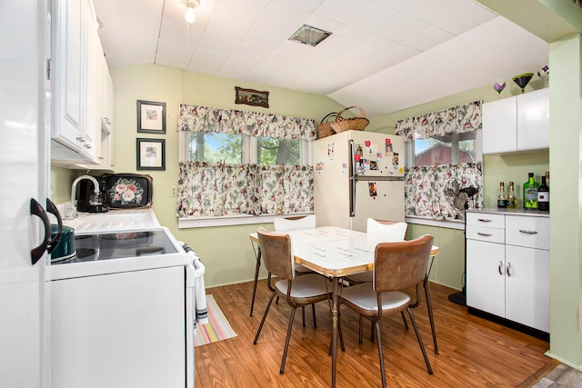 kitchen featuring white cabinetry, plenty of natural light, and white appliances