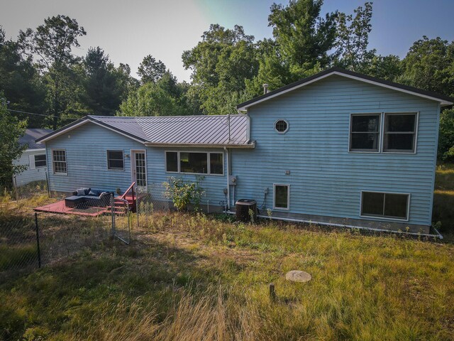 back of property featuring central AC unit