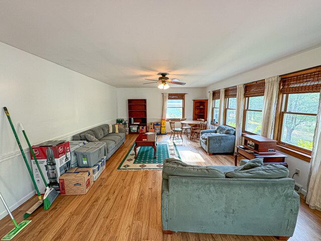 living room featuring hardwood / wood-style floors and ceiling fan