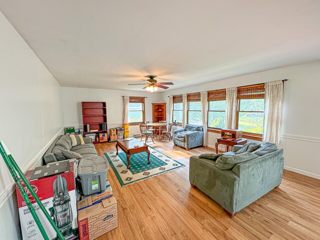 living room featuring light wood-type flooring, a wealth of natural light, and ceiling fan