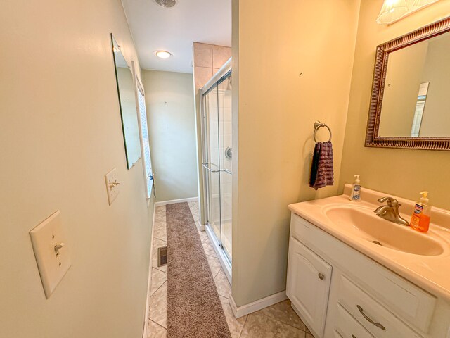 bathroom featuring tile patterned flooring, vanity, and an enclosed shower