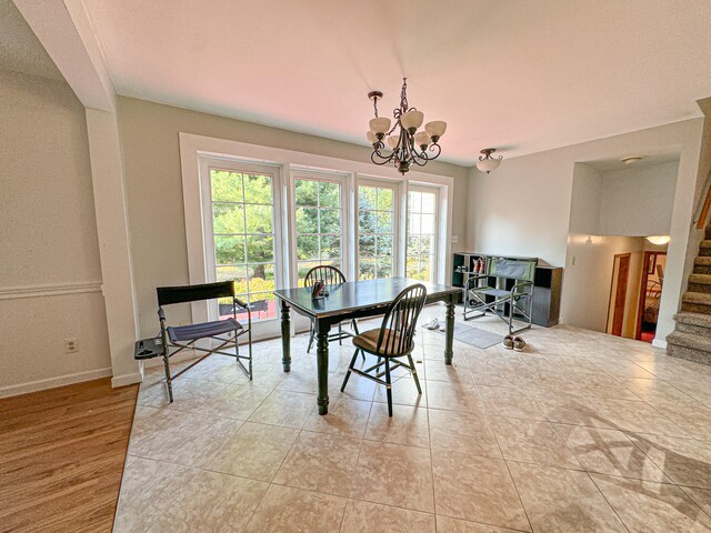 dining room with light tile patterned floors, a wealth of natural light, and a chandelier