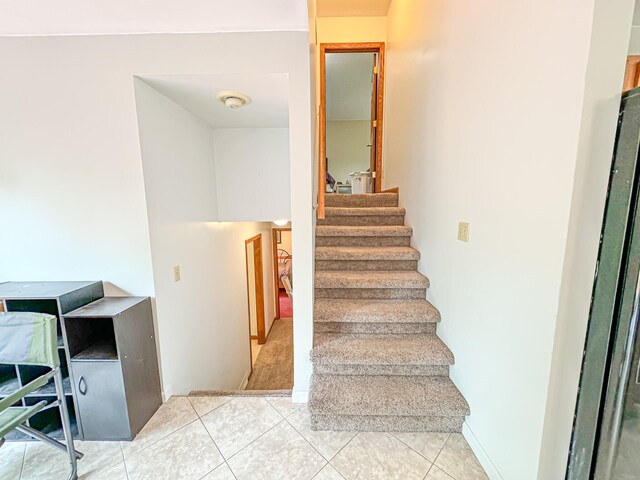 stairs with tile patterned floors