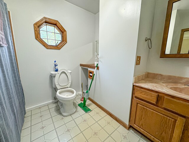 bathroom with vanity, toilet, and tile patterned floors