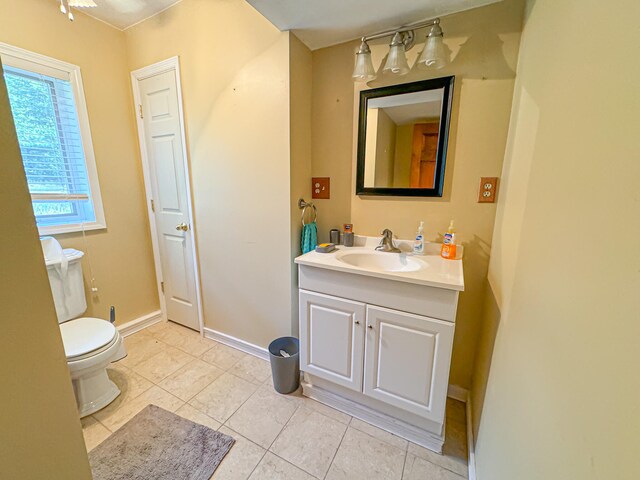 bathroom featuring vanity, toilet, and tile patterned flooring