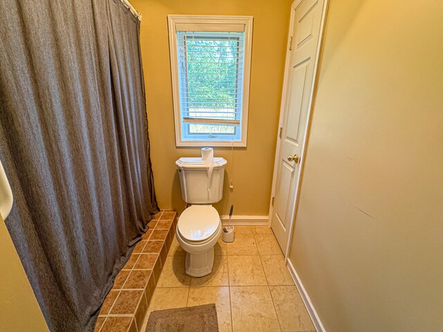 bathroom with toilet and tile patterned floors