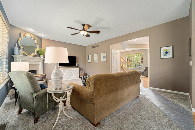 living room featuring carpet floors and ceiling fan