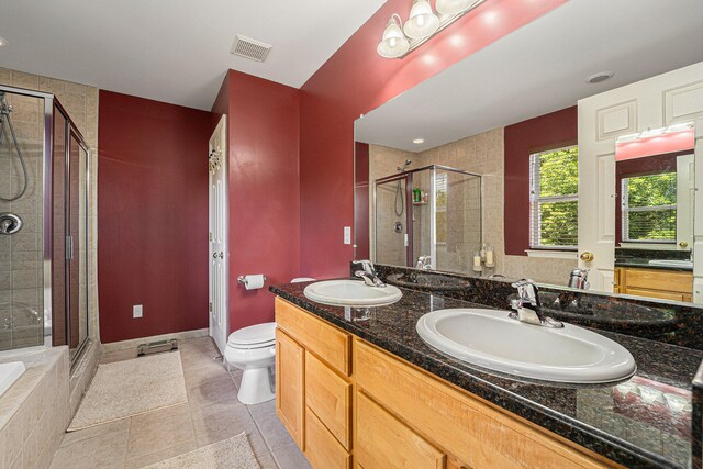 full bathroom featuring toilet, independent shower and bath, vanity, and tile patterned floors