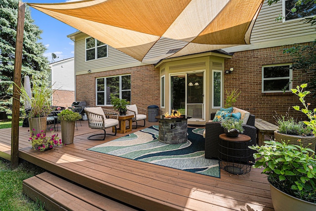 deck featuring a grill and a fire pit