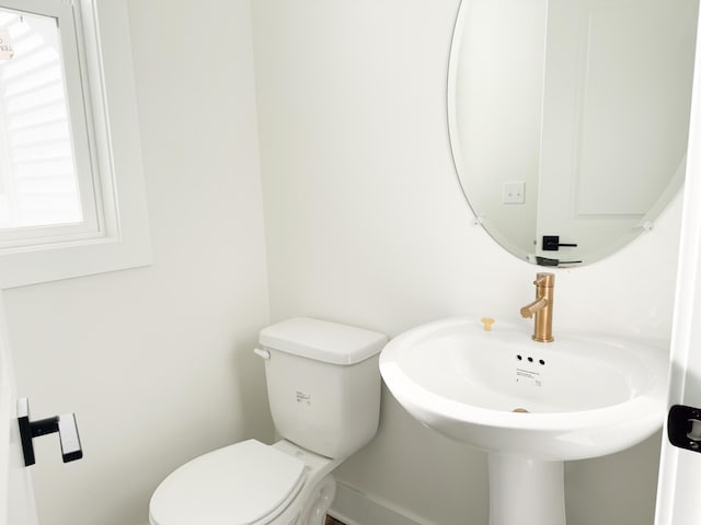 bathroom with toilet and a sink