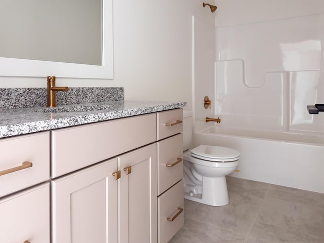 bathroom featuring tile patterned flooring, bathtub / shower combination, vanity, and toilet